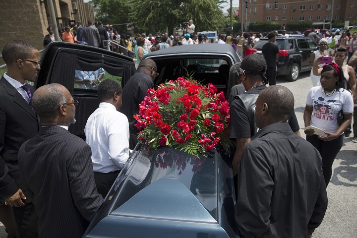 The casket of Samuel Dubose is transported to a hearse during his funeral at the Church of the Living God in the Avondale neighborhood of Cincinnati, Tuesday, July 28, 2015. Dubose was fatally shot by a University of Cincinnati police officer who stopped him for a missing license plate.