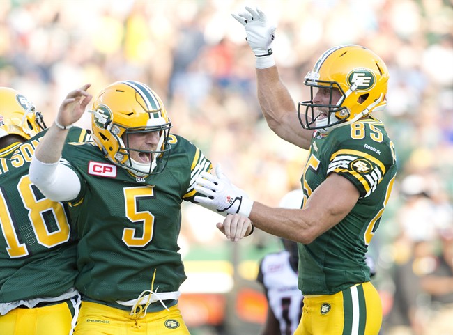 Edmonton Eskimos quarterback Jordan Lynch (5) and Nate Coehoorn (85) celebrate a touchdown against the Ottawa Redblacks during first half action in Edmonton, Alta., on Thursday July 9, 2015. 