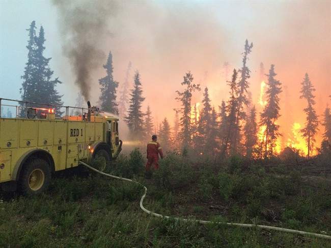 A fire crew battles a blaze in the La Ronge area on northern Saskatchewan, Saturday, July 4, 2016.