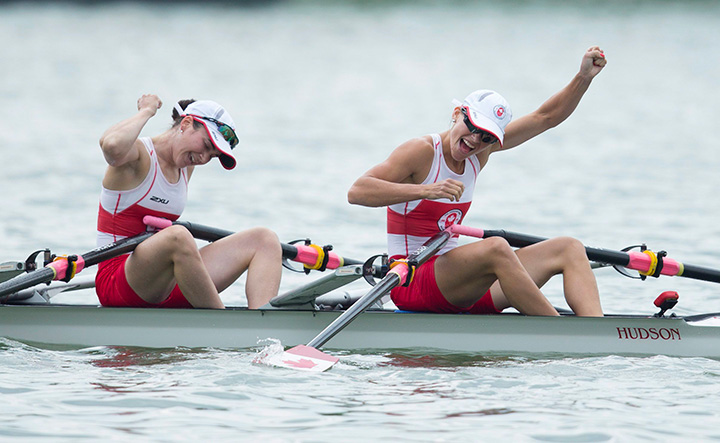 Canadians Liz Fenje, left, and Katherine Sauks celebrate after winning gold in the women's lightweight double sculls at the 2015 Pan Am Games at the Royal Canadian Henley Rowing Course in St. Catharines, Ont., on Tuesday, July 14, 2015. 