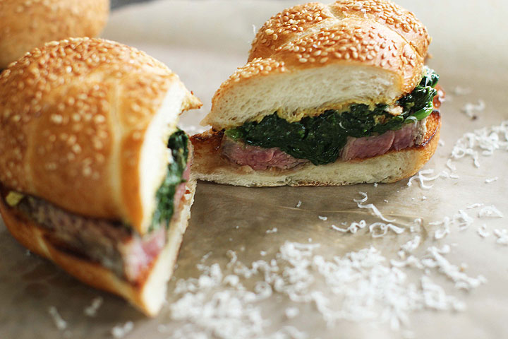 This June 15, 2015 photo shows marinated flank steak with seared spinach in Concord, N.H. This dish is from a recipe by Alison Ladman.
