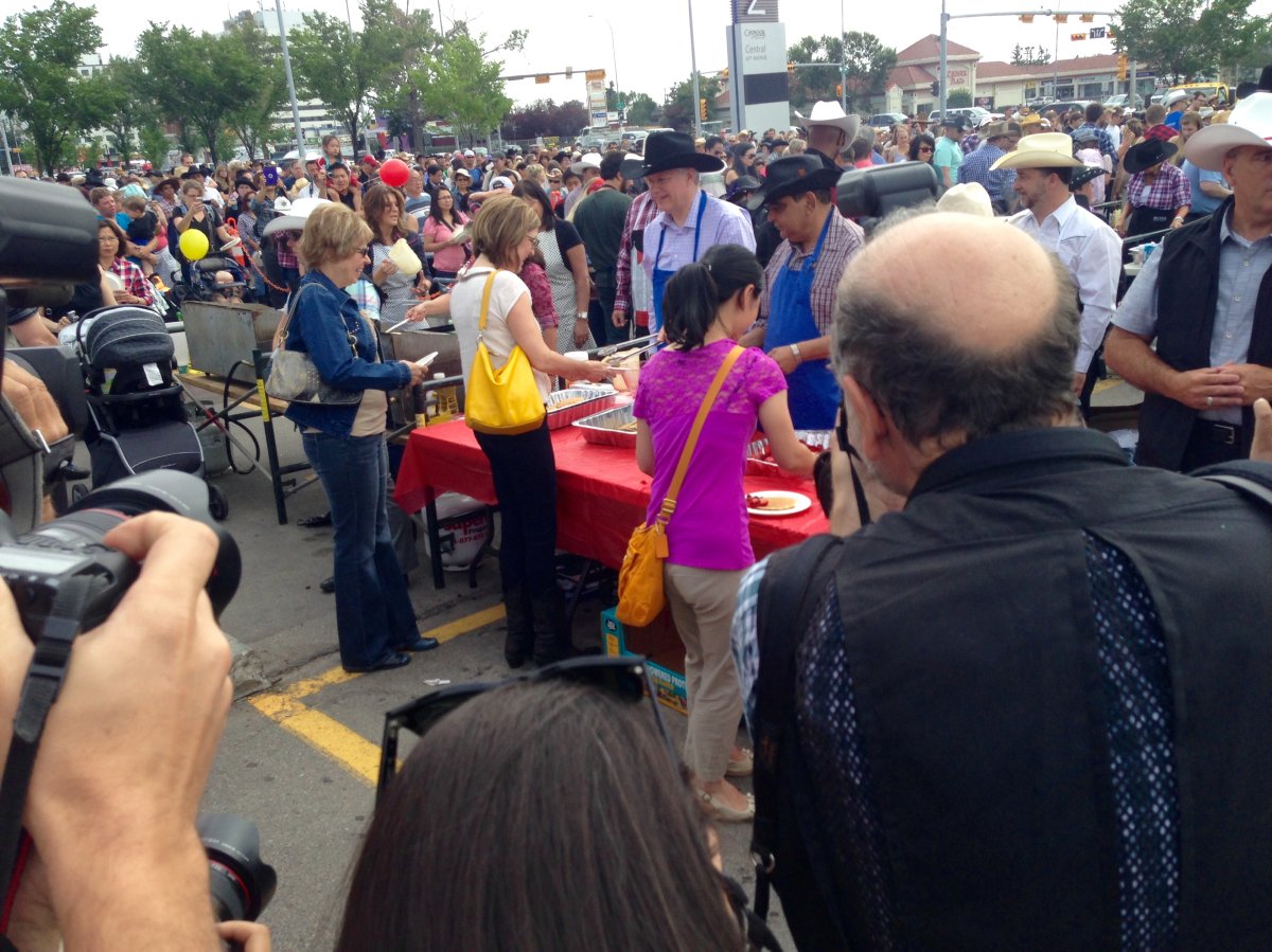 Prime Minister Stephen Harper serves pancakes at annual Chinook Stampede Breakfast.