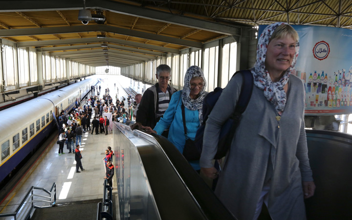 European tourists stand on a platform at a station in Tehran after arriving in the Iranian capital on a luxury train from Budapest.