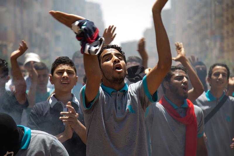 Egyptians, who call themselves as an anti-coup group, shout slogans and light flares as they protest against the coup regime and the mass death sentence decisions including Egypt's former president Mohamed Morsi, in Giza, Egypt on July 3, 2015.