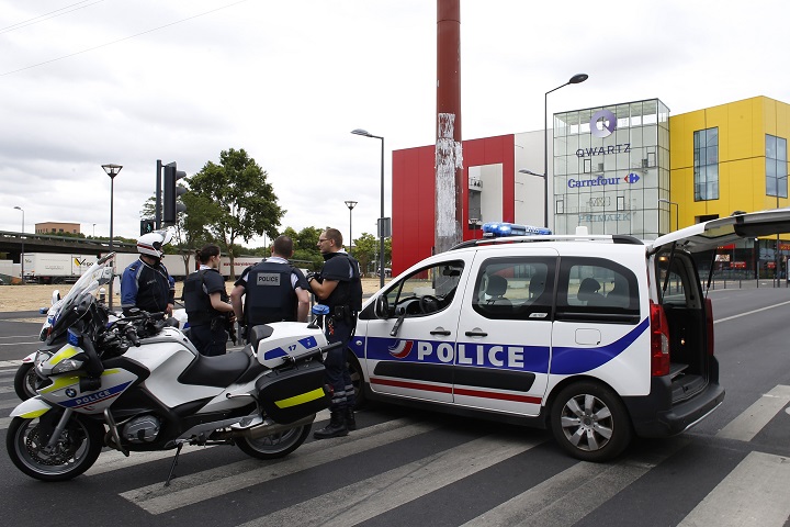 French police officers stand outside the Qwartz mall in Villeneuve-La-Garenne after a robbery attempt on July 13, 2015. Special forces evacuated 18 people from a mall near Paris today after gunmen attacked a Primark store inside, in what was thought to be an attempt to rob the shop, police said.   