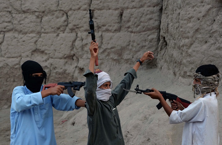 In this photograph taken on July 18, 2015, Afghan children play with plastic guns as they celebrate the second day of Eid al-Fitr which marks the end of the holy fasting month of Ramadan, on the outskirts of Jalalabad city in eastern Nangarhar province. 