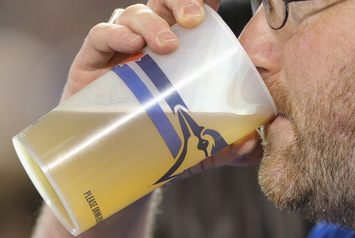 A fan drinks from a cup of beer during the Toronto Blue Jays MLB game against the Los Angeles Angels of Anaheim on May 10, 2014 at Rogers Centre in Toronto, Ontario, Canada. (Photo by Tom Szczerbowski/Getty Images).