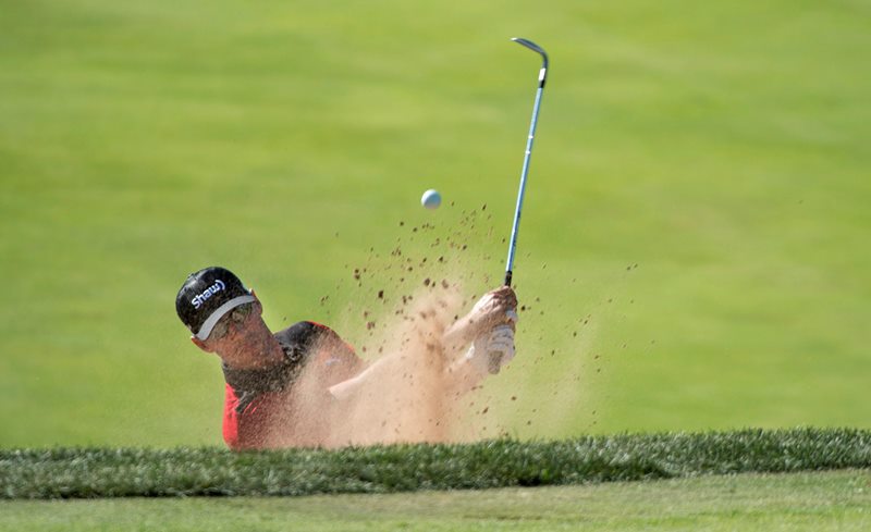 AppleMarkGraham DeLeat, left, from Weyburn, Sask. hits out of a sans trap onto the 16th green during first round of play at the Canadian Open golf tournament Thursday, July 23, 2015 in Oakville, Ont.