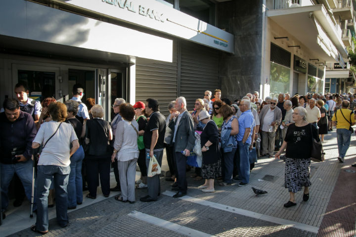 Anxious crowds of elderly Greeks queue outside banks open specifically for pensioners who don't have bank cards on July 2, 2015, allowing them to access some of their money.