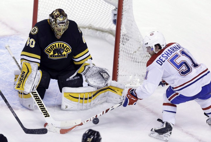 Boston Bruins goalie Tuukka Rask, of Finland, deflects a shot on goal by Montreal Canadiens center David Desharnais (51) during the second period of an NHL hockey game, Sunday, Feb. 8, 2015, in Boston.