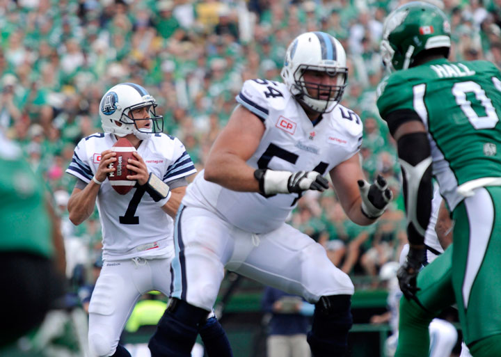 Trevor Harris of the Toronto Argonauts looks for a receiver as offensive lineman Chris Van Zeyl guards his flank during first half CFL action against the Saskatchewan Roughriders in Regina on Sunday, July 5, 2015. THE CANADIAN PRESS/Mark Taylor
