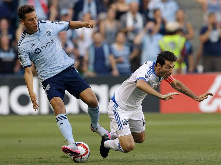 Sporting Kansas City forward Krisztian Nemeth, left, tackles the ball from Montreal Impact midfielder Ignacio Piatti during the first half of an MLS soccer match in Kansas City, Kan., Saturday, July 18, 2015. 