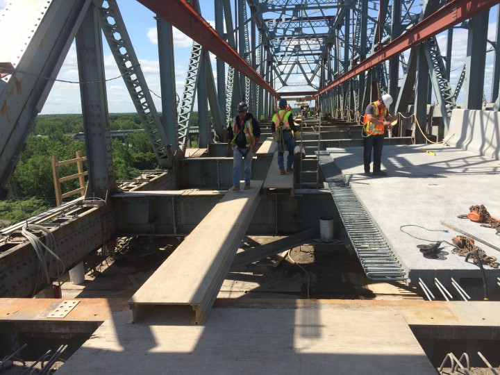 Workers on the Mercier Bridge laying new concrete decks, Wednesday, July 15, 2015.