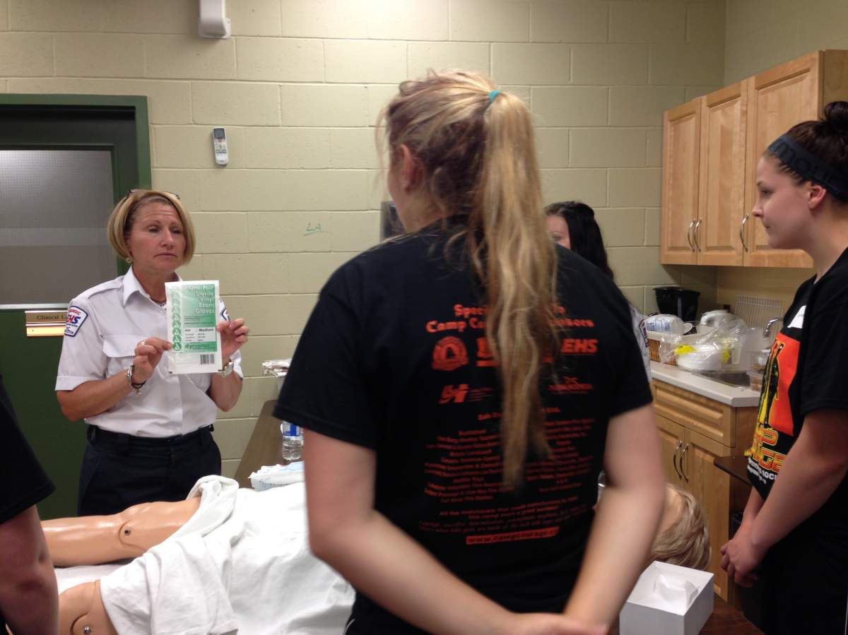 Students at Camp Courage learn how to deliver a baby with the use of a simulator mannequin.