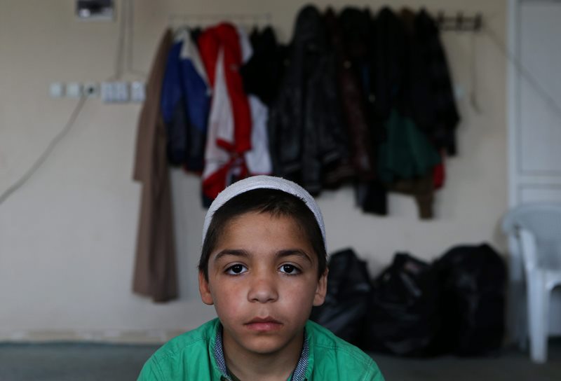 In this April 19, 2015 picture, Syrian boy Ahmad, 7, whose parents went missing in Syria, attends a class of religious lessons at an Islamic teaching center designed to counter Islamic State group indoctrination, near the Turkish-Syrian border city of Sanliurfa, southern Turkey. 