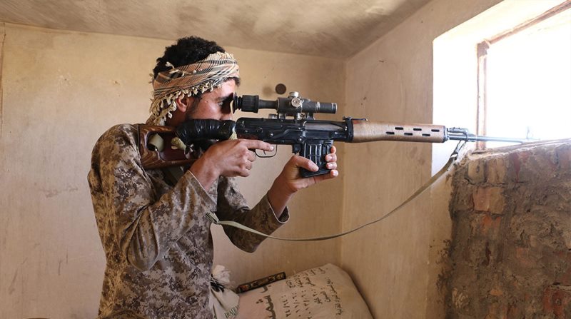 In this photo released on June 23, 2015, by a website of Islamic State militants, an Islamic State militant looks through the scope of his rifle in Kirkuk, northern Iraq. Though best known for its horrific brutalities _ from its grotesque killings of captives to enslavement of women _ the Islamic State group has proved to be a highly organized and flexible fighting force, according to senior Iraqi military and intelligence officials and Syrian Kurdish commanders on the front lines.
