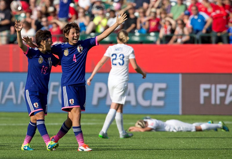 Japan's Saori Ariyoshi (19) and Saki Kumagai (4) celebrate the win over England in FIFA Women's World Cup semi-final soccer action in Edmonton on Wednesday July 1, 2015.