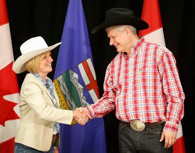 Alberta Premier Rachel Notley, left, greets Prime Minister Stephen Harper with a handshake in Calgary, Alta., on Monday, July 6, 2015. 