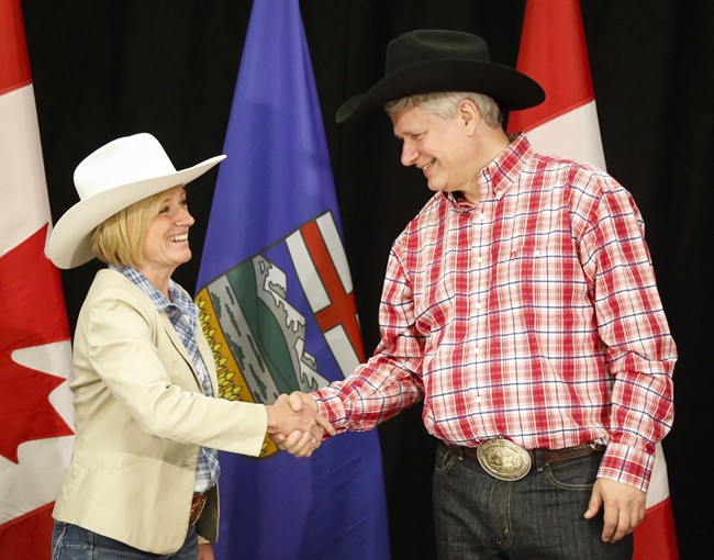 Alberta Premier Rachel Notley, left, greets Prime Minister Stephen Harper with a handshake in Calgary, Alta., on Monday, July 6, 2015. 