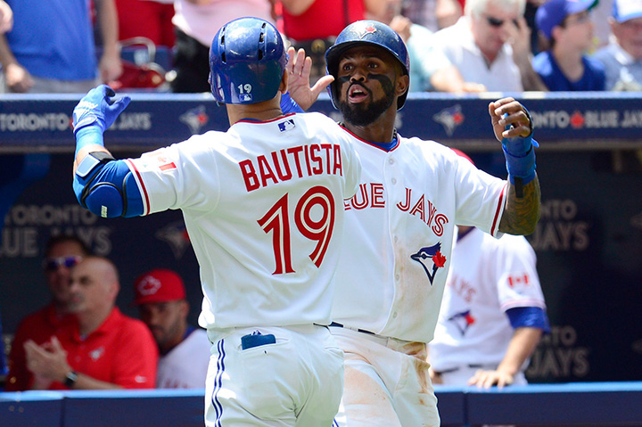 Toronto Blue Jays Jose Bautista is congratulated by teammate Jose Reyes after hitting a two-run home run against the Boston Red Sox during second inning American League action in Toronto on Wednesday, July 1, 2015. 