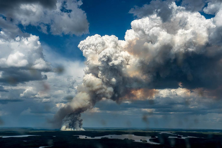 A massive plume of smoke rises from a wildfire in the La Ronge, Sask. Claude Resources has suspended mining operations at its Seabee Gold Mine due to the proximity of a wildfire.