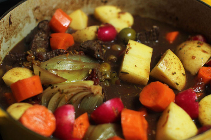 This June 15, 2015 photo shows baked mediterranean lamb stew in Concord, N.H. This dish is from a recipe by Alison Ladman.
