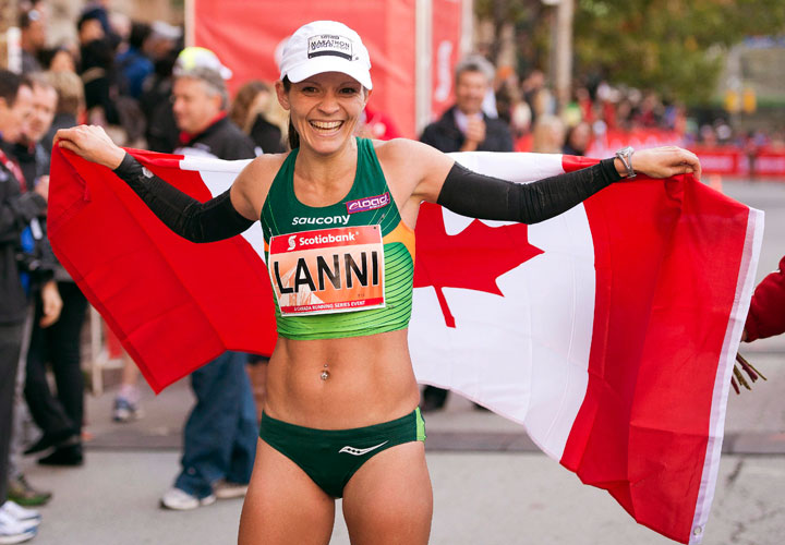Lanni Marchant celebrates after crossing the line to set a new Canadian record at the Toronto Waterfront Marathon on Sunday with a time of 2:27:59 on Sunday October 20, 2013.
