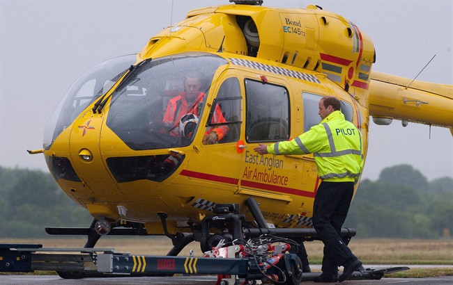 Prince William, the Duke of Cambridge prepares to board an East Anglian Air Ambulance (EAAA) at Cambridge Airport, Cambridge, in England, Monday July 13, 2015.