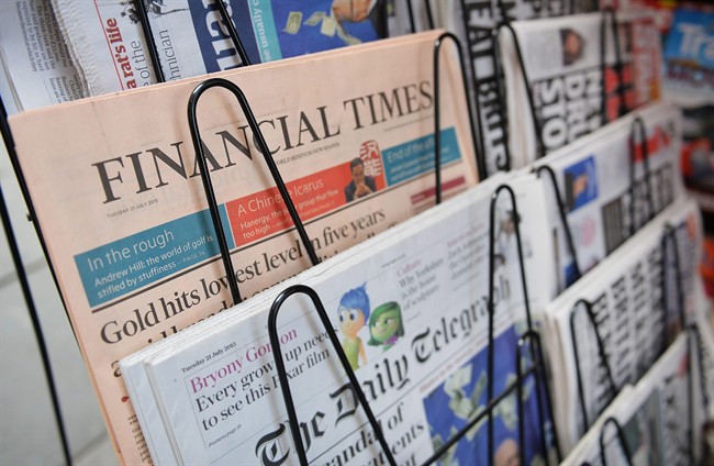 In this photo taken on Tuesday, July 21, 2015, the Financial Times Newspaper is seen on sale at a newsagents in London. 