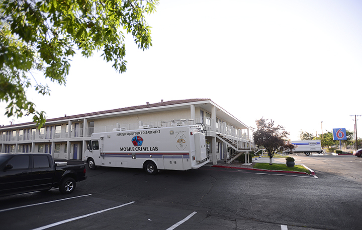 An Albuquerque Police Department Mobile Crime Lab is parked outside a Motel 6, Wednesday, July 1, 2015, where a man was found dead and another injured during what police say was an altercation between the two late Tuesday in Albuquerque, N.M. 