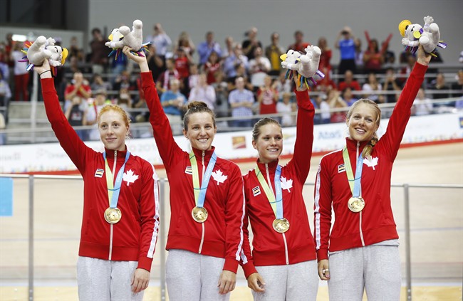 Canada's left to right, Allison Beveridge, Laura Brown, Jasmin Glaesser, and Kirsti Lay celebrate with their gold medals following the track cycling women's team pursuit finals at the Pan Am Games in Milton, Ont., Friday July 17, 2015.