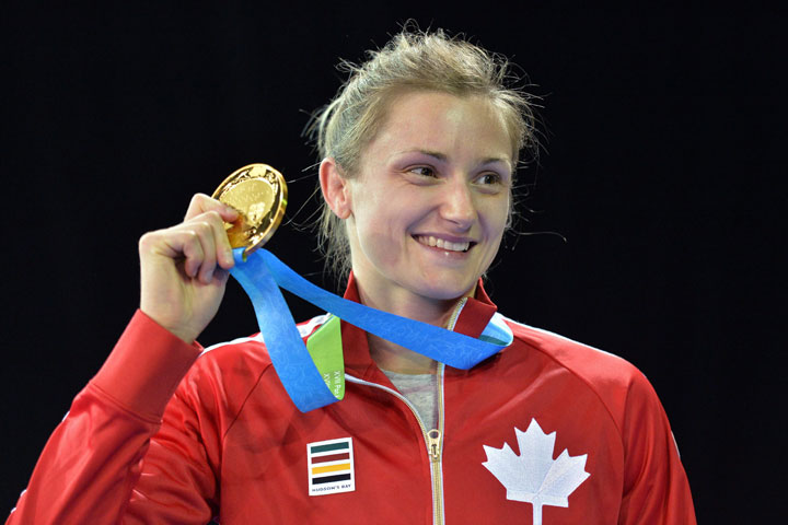 Gene Morrison of Canada holds her gold medal after defeating Thalia Mallqui of Peru in the women's freestyle 48kg final during the Pan American Games in Toronto on Thursday, July 16, 2015.