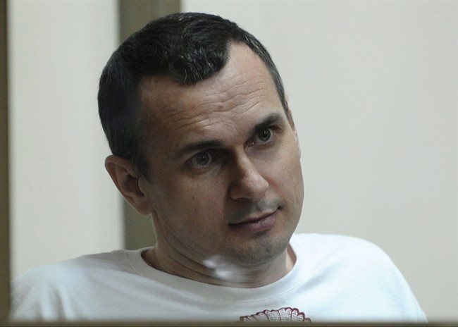Oleg Sentsov sits behind glass in a cage at a court room in Rostov-on-Don, Russia, Tuesday, July 21, 2015.