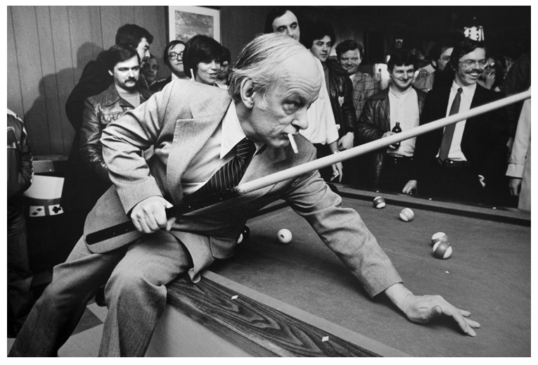 René Lévesque shooting pool with a cigarette between his lips.