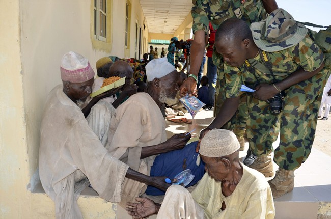 Men and children rescued by Nigerian soldiers from Boko Haram extremists in northeast Nigeria, eat a meal on their arrival at the military office in Maiduguri, Nigeria, Thursday, July 30, 2015. Soldiers rescued 71 people, almost all girls and women, in firefights that killed many Boko Haram militants in villages near the northeastern city of Maiduguri, Nigeria’s military said Thursday. (AP Photo/Jossy Ola).