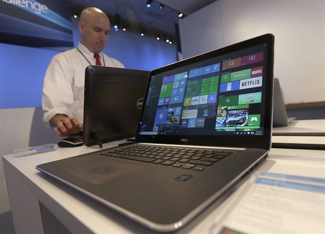 In this April 29, 2015 file photo, a Dell laptop computer running Windows 10 is on display at the Microsoft Build conference in San Francisco. 