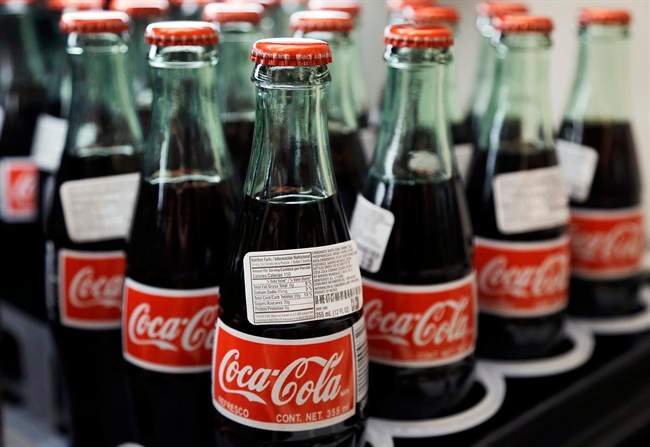 In this July 9, 2015 photo, bottles of Coca-Cola are on display at a Haverhill, Mass. supermarket.