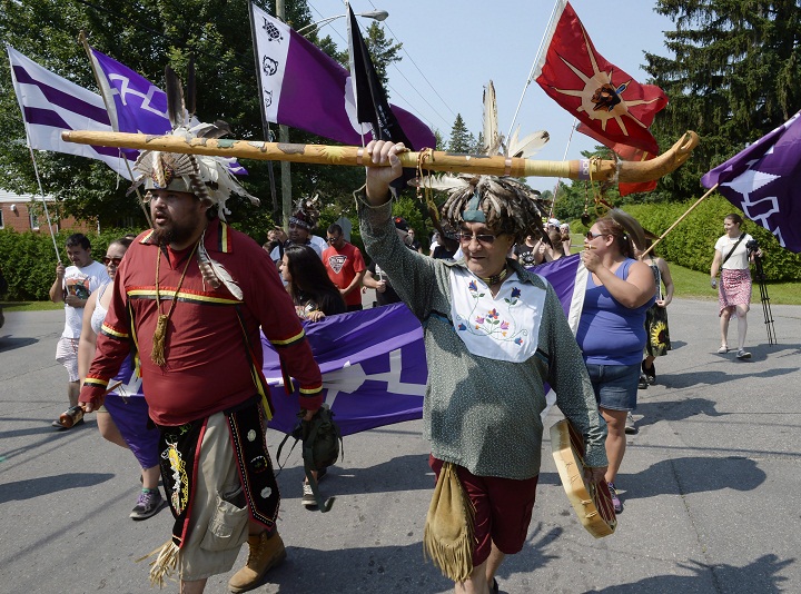 Mohawks from Kanesatake, Que., march to mark the 25th anniversary of the Oka Crisis, in Oka, Que., on Saturday, July 11, 2015. 