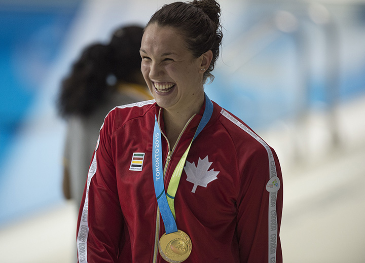 Canada’s Chantal Van Landeghem celebrates winning the gold medal in the Women's 100M Freestyle finals at the 2015 Pan American Games in Toronto, Canada, July 14, 2015.   