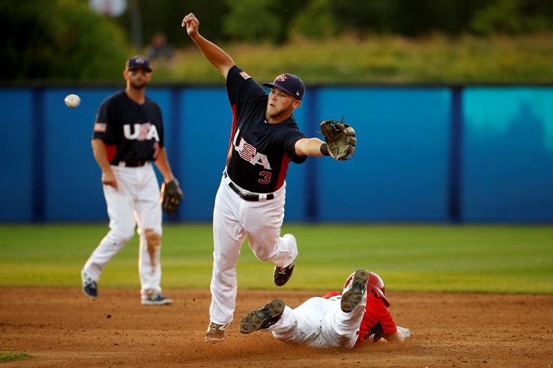 United States second baseman Jacob Wilson, center, is unable to catch an errant throw from catcher Thomas Murphy as Canada’s Peter Orr, right, steals second base during the fifth inning of the gold medal baseball game at the Pan Am Games, Sunday, July 19, 2015, in Ajax, Ontario.