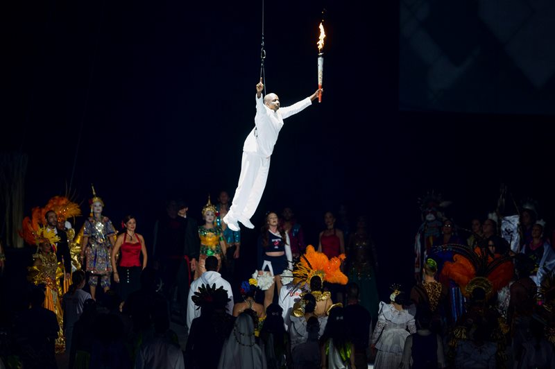 Former Olympian and world record sprinter Donovan Bailey is lowered into the Rogers Centre with the Pan Am flame during the 2015 Toronto Pan Am Games opening ceremony at the Rogers Centre on Friday, July 10, 2015. 
