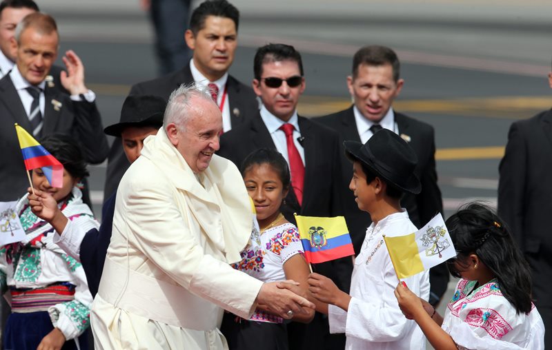Pope Francis greets several children upon his arrival to the Mariscal Sucre International airport in Quito Sunday July 5, 2015. History's first Latin American pope returns to Spanish-speaking South America for the first time on Sunday to visit Ecuador, Bolivia and Paraguay.