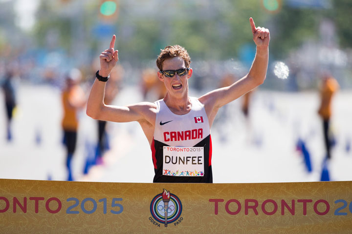 Canada's Evan Dunfee crosses the finish to win the men's 20km race walk at the Pan Am Games in Toronto, Ontario, Sunday, July 19, 2015.