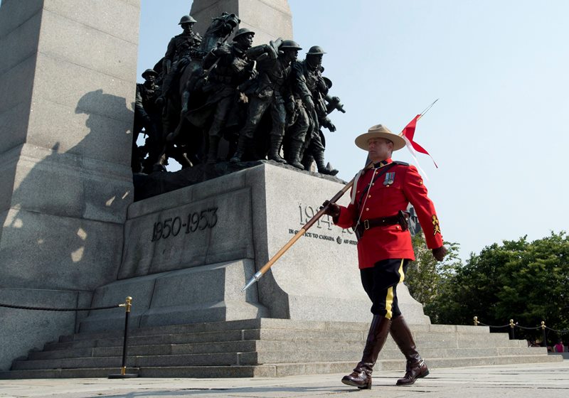 RCMP members stand guard at the Tomb of the Unknown Soldier, Sunday, July 5, 2015 in Ottawa. The RCMP is guarding the National War Memorial to mark the anniversary of the date Sgt. Arthur Richardson earned the Victoria Cross. Richardson was the first soldier to be awarded the Victoria Cross for actions committed while serving with a Canadian unit under British command.