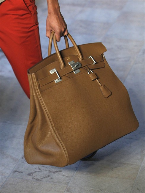 This June 25, 2011 file photo shows a model carrying a Birkin handbag.