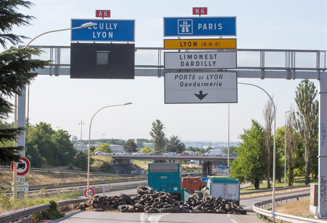 Farmers barricade the highway leading Paris to Lyon in Limonest near Lyon, central France, Thursday, July 23, 2015. 