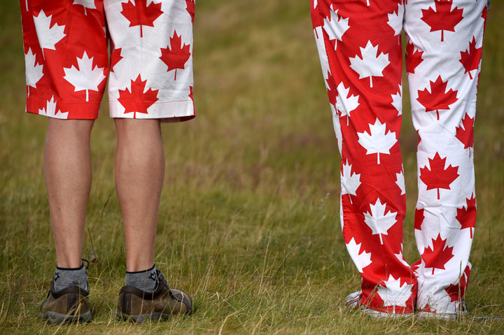 Fans in Canadian flag attire follow Graham Delaet of Canada during the first round of the 144th Open Championship at The Old Course on July 16, 2015 in St Andrews, Scotland.