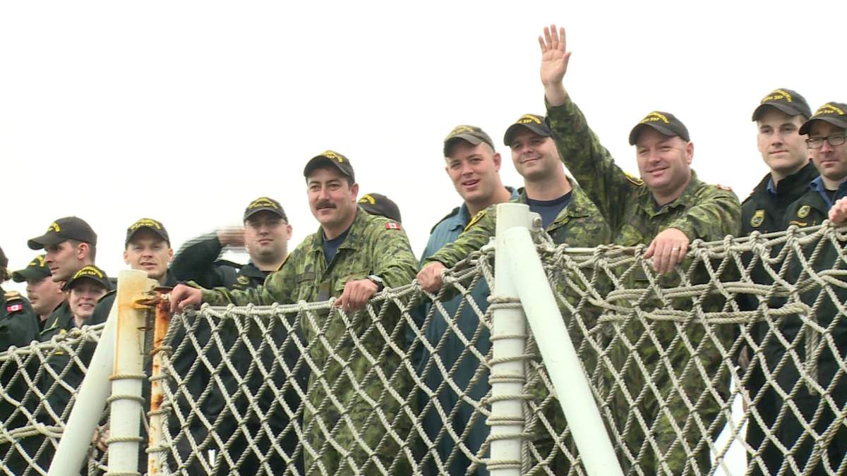 Sailors aboard HMCS Fredericton wave to the crowds.