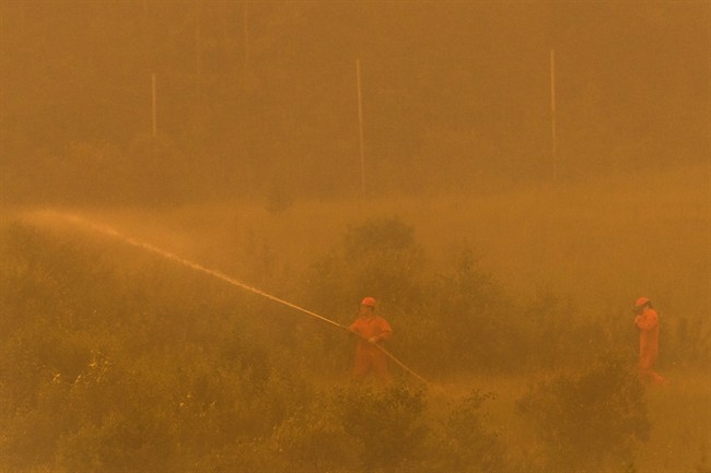 A firefighting crew is seen in the La Ronge, Sask., area in this July 5, 2015 handout photo. About 1,000 wildfire evacuees able to go home as evacuation order lifted for Pinehouse.