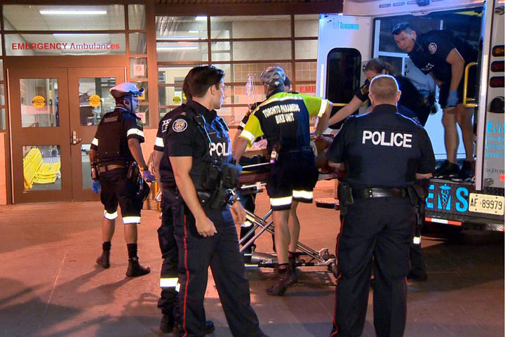 Paramedics arrive at hospital in Toronto with man shot by police in downtown Entertainment District.